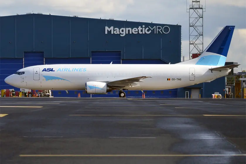 ASL Airlines Belgium Boeing 737-4M0 BDSF parked on the runway with Magnetic MRO hangar in the background.