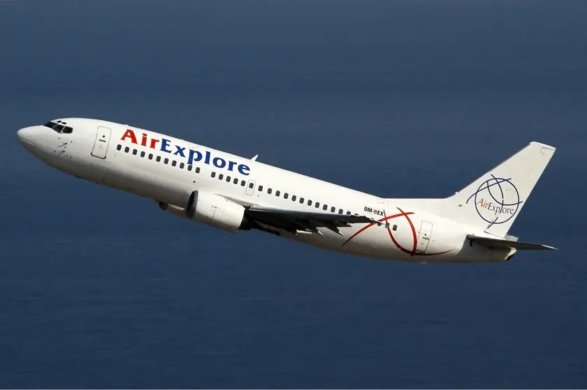 AirExplore Boeing 737-300 aircraft in flight against a clear sky background.