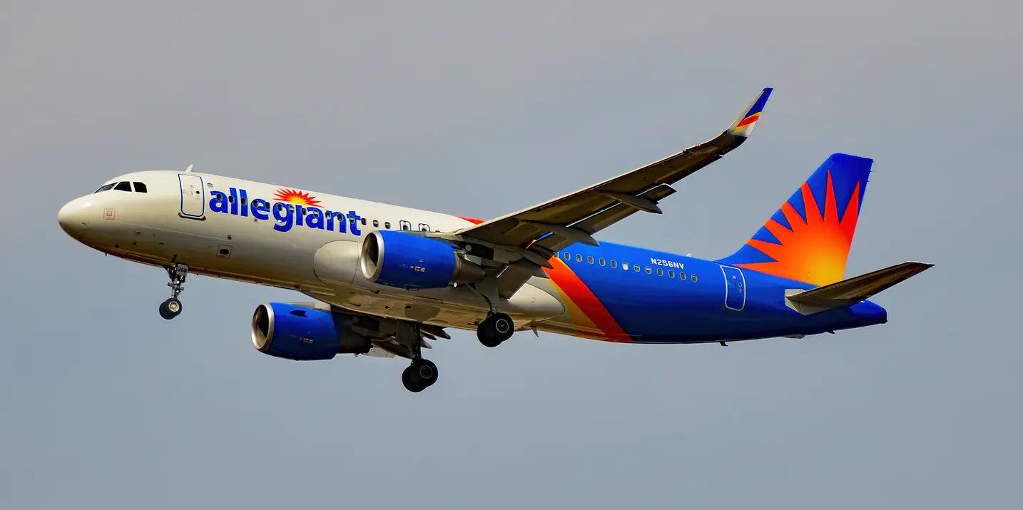 Allegiant Air Airbus A320-214 aircraft in flight with landing gear extended, showing blue and orange livery and N256NV registration.