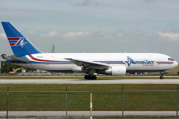 Amerijet International Boeing 767-200 aircraft on the runway, side view with blue and red livery and logo, preparing for takeoff.
