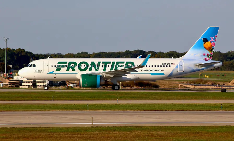 Frontier Airlines Airbus A320 named 'Cookie the Oriole' with an oriole bird illustration on the tail, parked on an airport runway.