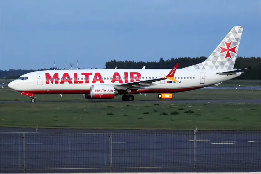 Side view of Malta Air Boeing 737-8-200 MAX on a runway, marked with registration 9H-VUF, featuring red and white livery and a Maltese cross on the tail.