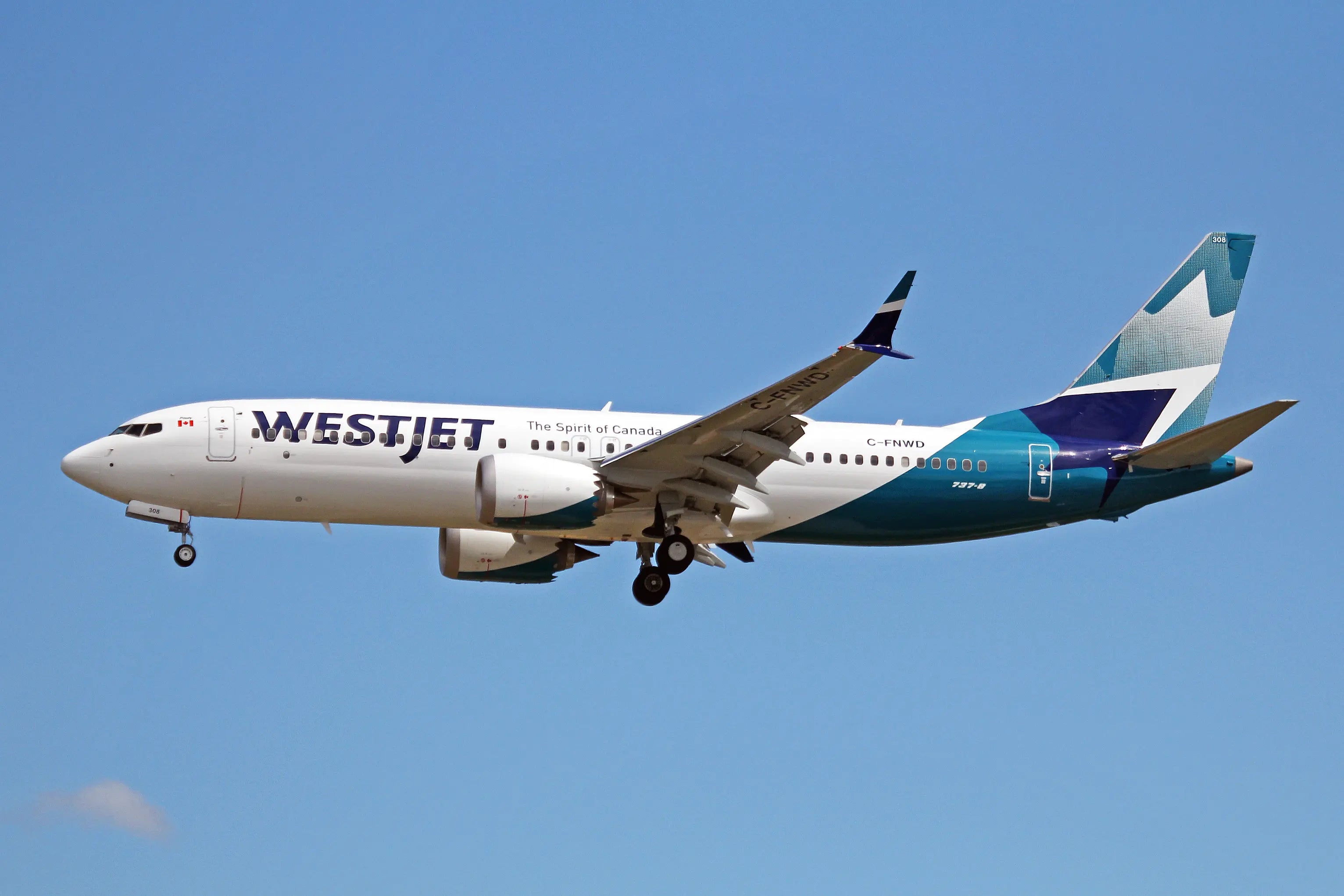 WestJet Airlines Boeing 737 MAX 8 in flight with blue sky background, showing the aircraft's livery and registration number C-FNWD.