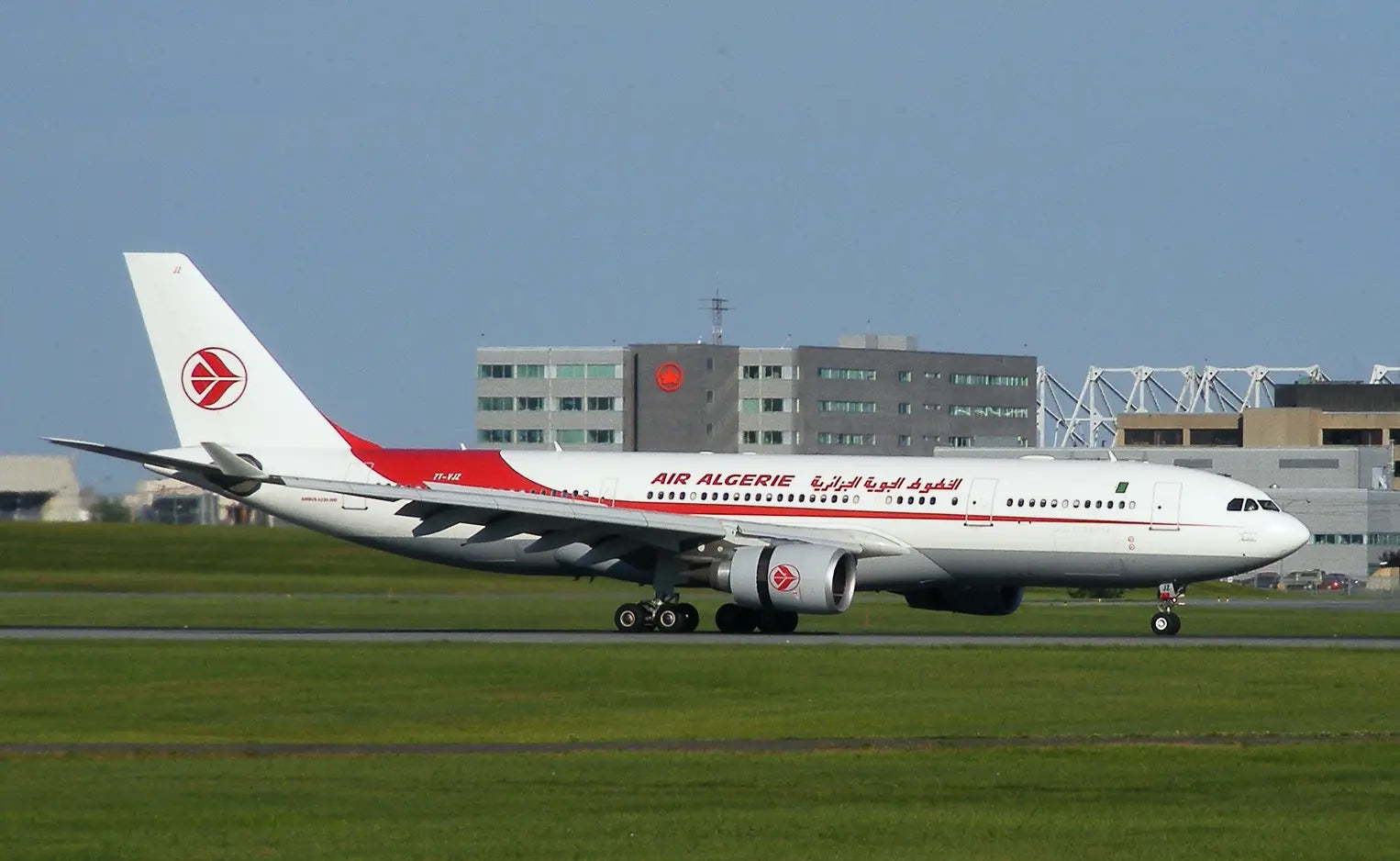 Air Algérie Airbus A330 aircraft taxiing on the runway at Montreal-Pierre Elliott Trudeau International Airport with terminal buildings in the background.