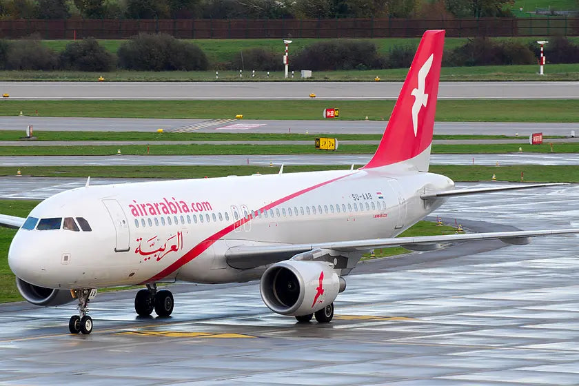 Air Arabia Airbus A320 aircraft SU-AAB taxiing on a wet runway at Zurich Airport.
