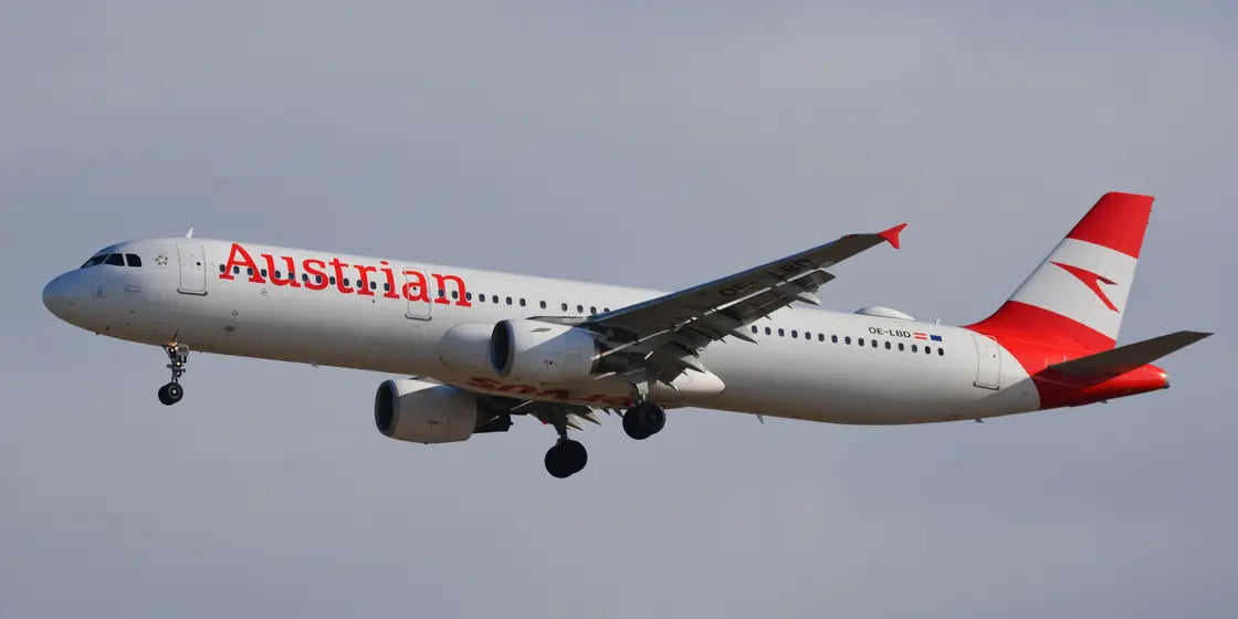 Austrian Airlines Airbus A321-200 aircraft OE-LBD in flight against a clear sky with landing gear deployed.