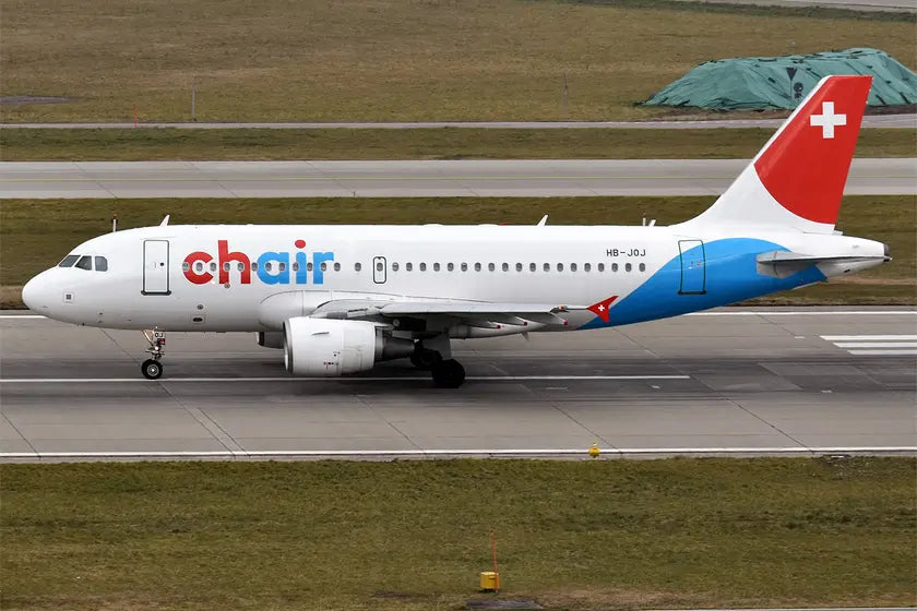 Chair Airlines Airbus A319-112 with registration HB-JOJ taxiing on a runway, showing its distinctive red and blue livery with a Swiss flag on the tail.
