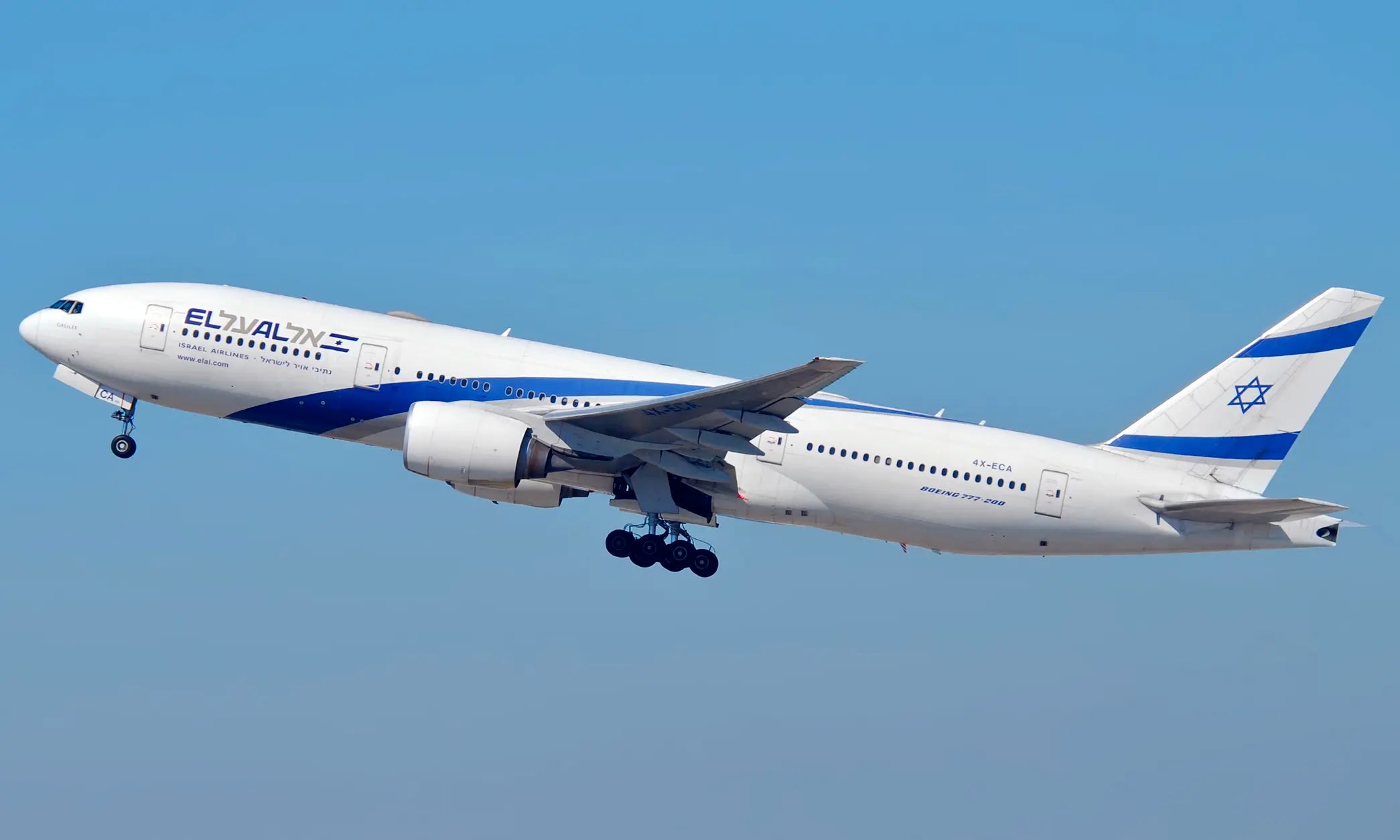 El Al Boeing 777-200ER aircraft, registration 4X-ECA, taking off into a clear blue sky with landing gear visible.