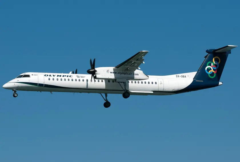Bombardier Dash 8-Q402 aircraft of Olympic Air in flight, showing its landing gear, propellers, and Olympic logo on the tail against a clear blue sky.