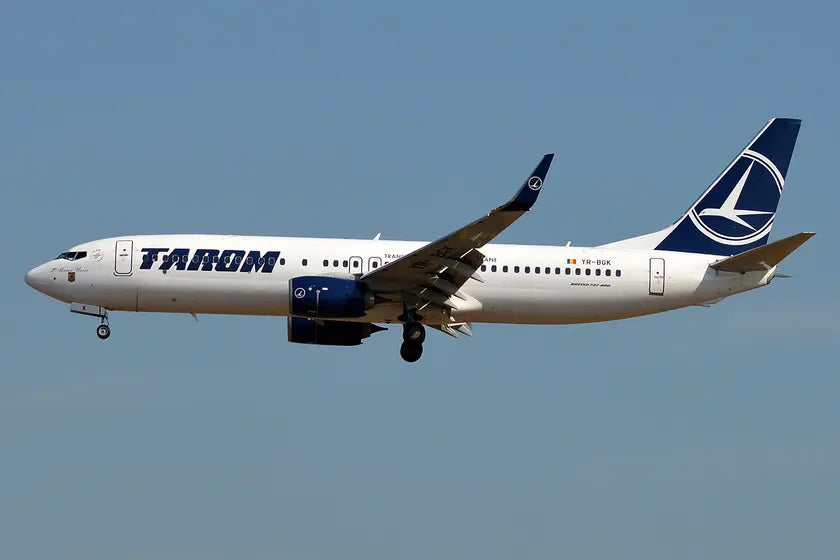 Tarom Boeing 737-82R aircraft in flight, marked YR-BGK, with a clear blue sky in the background, viewed from the left side.