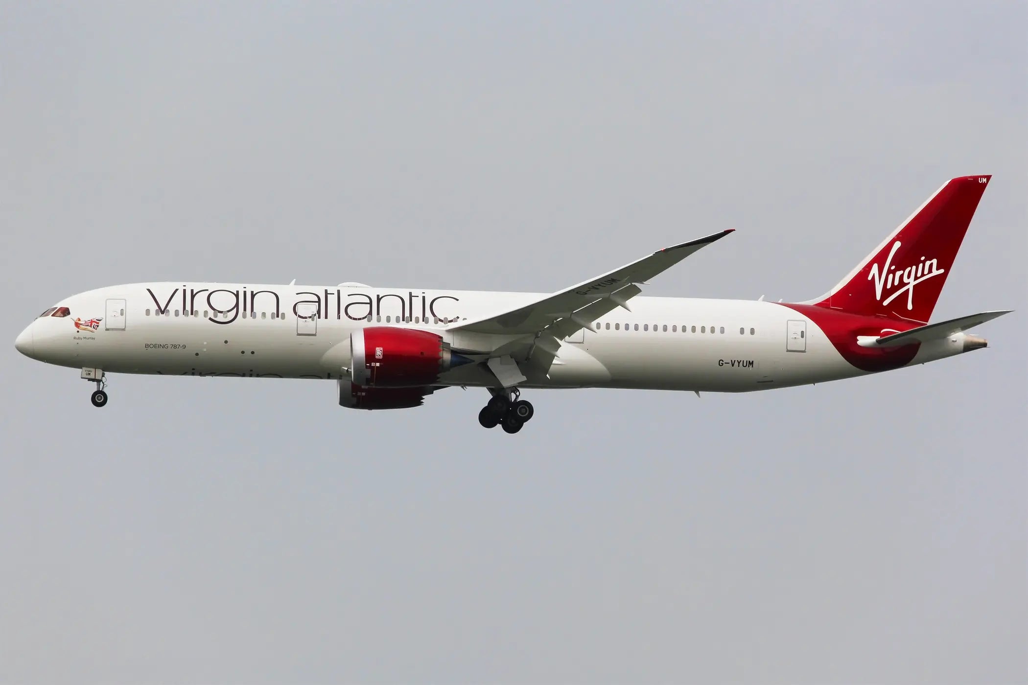 Virgin Atlantic Boeing 787-9 Dreamliner jet with registration G-VYUM in flight against a clear sky.