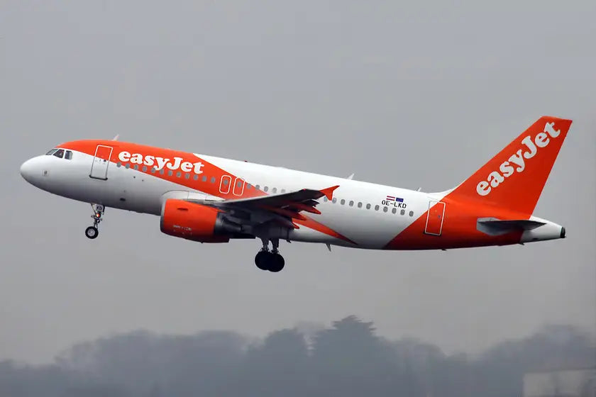 EasyJet Europe Airbus A319-111 aircraft, registration OE-LKD, taking off in overcast weather, featuring the airline's distinctive orange and white livery.